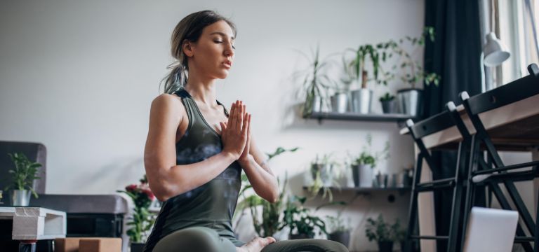 Mujer joven haciendo Yoga, eliminando los Chakras
